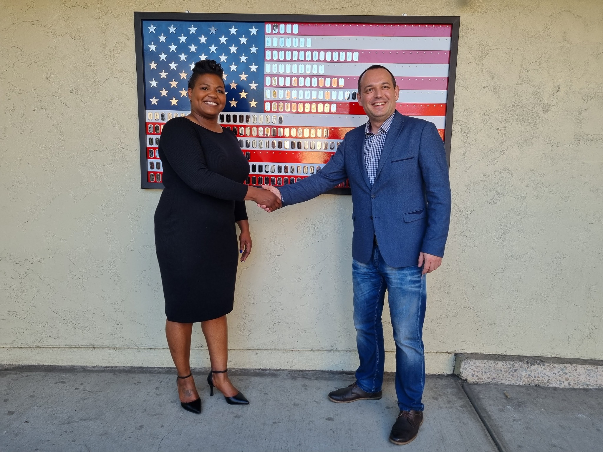 Andrii Vasyliev at an international meeting with a U.S. flag in the background