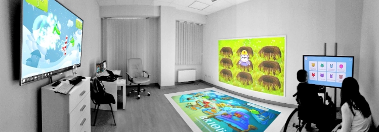 A child works with a specialist in an inclusive space with Briolight interactive equipment